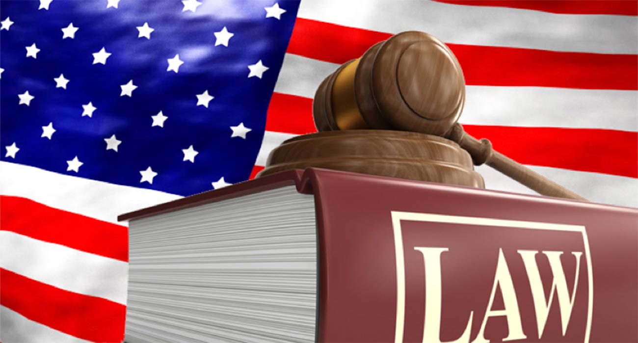 American flag, gavel and large book with Law typed on spine