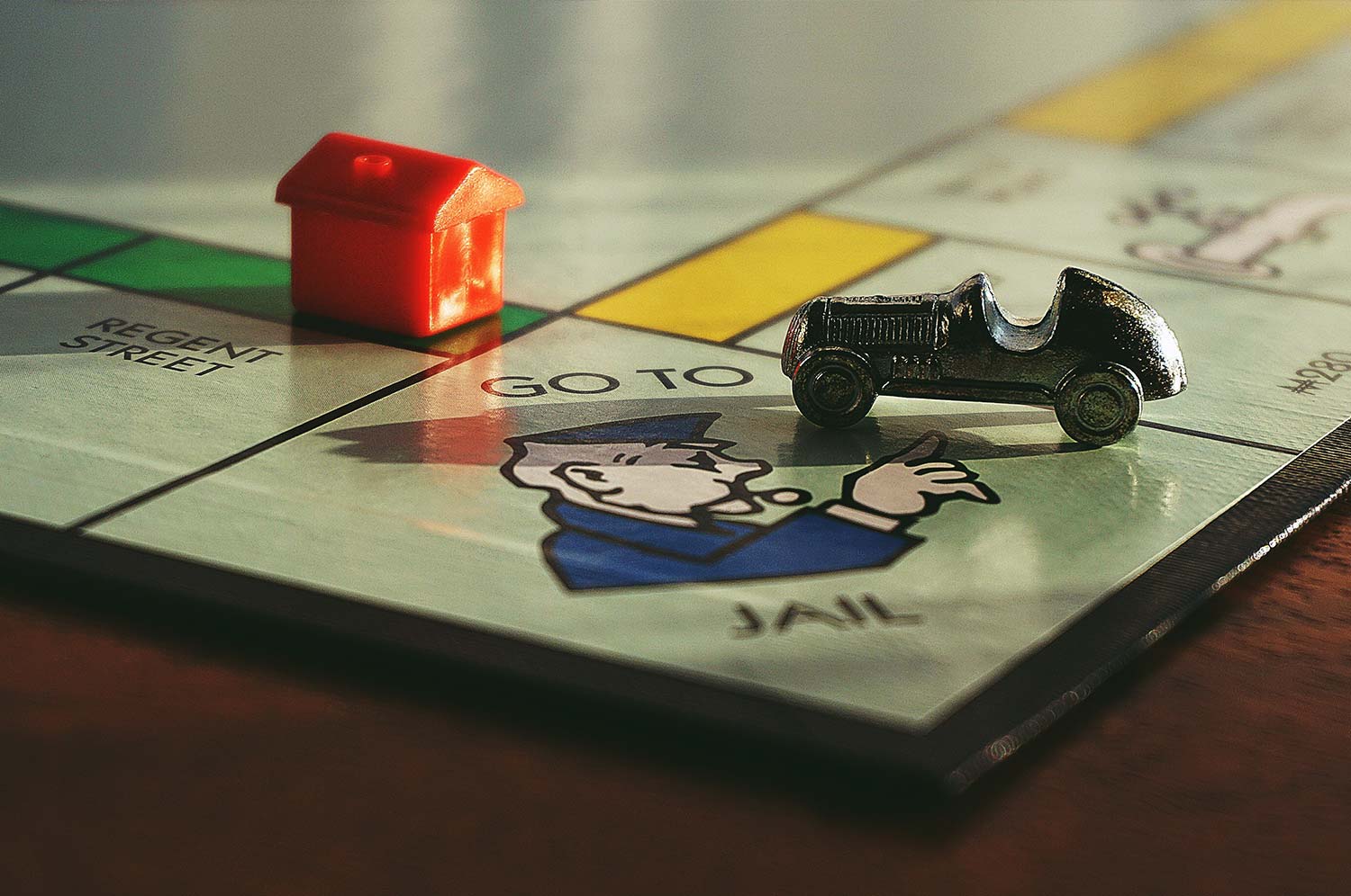 Monopoly piece landing on 'Go Back To Jail' spot