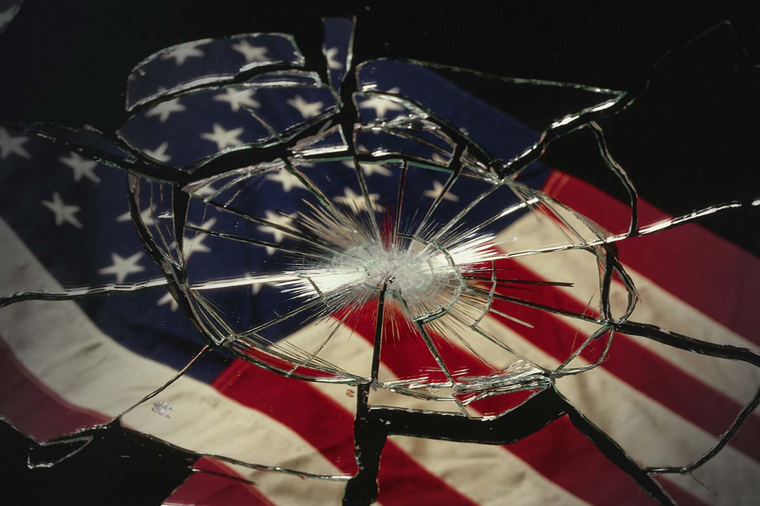 broken glass reflecting an american flag